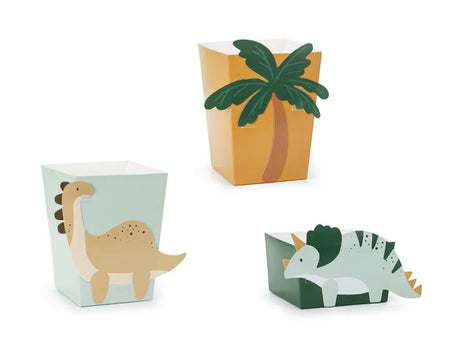 Drie snackdozen met dinothema: twee lichtgroene dozen met dinosaurussen en een gele doos met een palmboom.